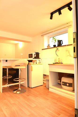 a kitchen with a counter and a stool in a room at Wave Rider's Nook in Oostduinkerke