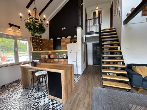 a kitchen and living room with a spiral staircase in a house at Lola hill house in Rovače