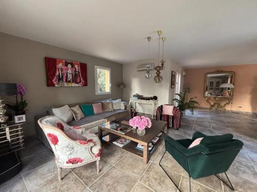 a living room with a couch and a table at Villa moderne avec piscine à Saint-Siffret_2 in Saint-Siffret