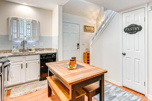 a kitchen with white cabinets and a wooden table at 1 Mi to Mohegan Sun Studio with Pool Access in Norwich