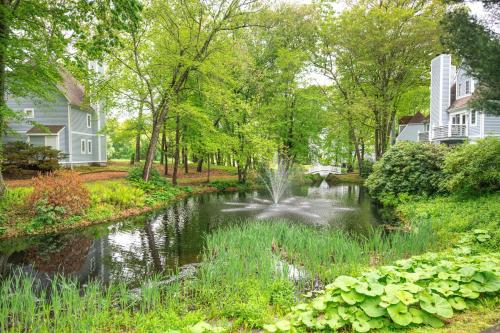 a pond with a fountain in the middle of a yard at 1 Mi to Mohegan Sun Studio with Pool Access in Norwich