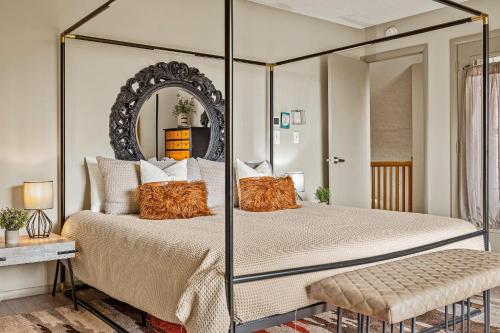 a bedroom with a four poster bed with a mirror at Emerald Bluff by AvantStay Lake Views Deck Fire Pit Game Room in Long Pond