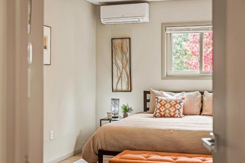 a bedroom with a bed and a window at Emerald Bluff by AvantStay Lake Views Deck Fire Pit Game Room in Long Pond