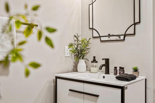 a white bathroom with a sink and a mirror at Emerald Bluff by AvantStay Lake Views Deck Fire Pit Game Room in Long Pond