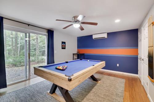 a pool table in a room with a ceiling fan at Moshannon Tree-Lined Pocono Retreat w Hot Tub Firepit Pool Table in Pocono Lake
