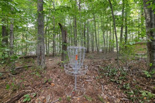 a metal frisbee golf basket in the woods at Moshannon Tree-Lined Pocono Retreat w Hot Tub Firepit Pool Table in Pocono Lake