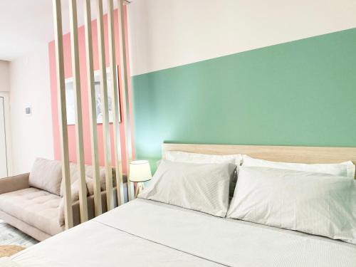 a bedroom with a bed and a couch at PROMO Cozy Apartments in Golem