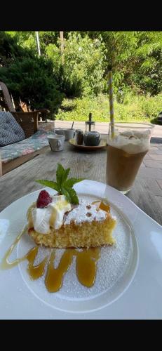 a piece of cake on a plate on a table at Penzion Troníček in Kamenný Přívoz