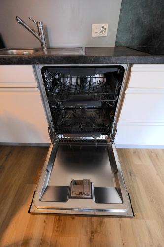 an oven with the dishes inside of it at Charming Studio - Ferienwohnung - Vulpera, Scuol in Scuol