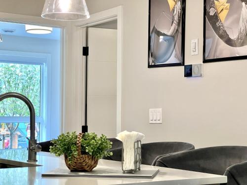 a dining room with a table and chairs at Brand New 2BR Condo with Outdoor Swimming Pool and Hot Tub in Canmore