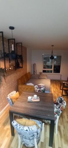 a living room with a table and a bed at Lux apartment 8, center, free parking in Niš
