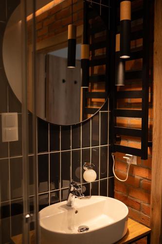 a bathroom with a sink and a mirror at Folwark Pszczew in Pszczew