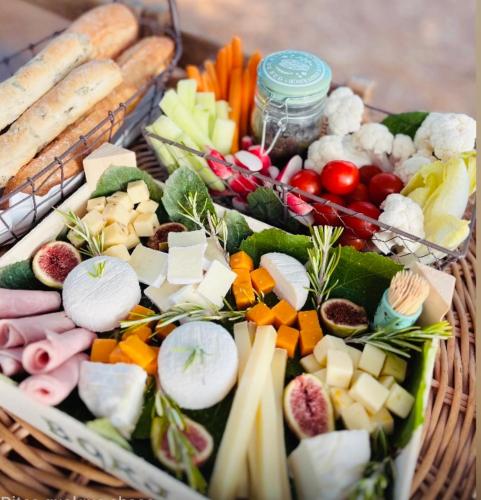 a basket filled with different types of cheese and vegetables at Authentique bergerie en pierre avec jacuzzi piscine et massages La grange des amoureux in Le Beausset