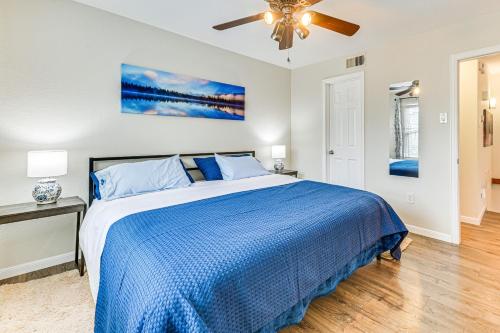a bedroom with a blue bed and a ceiling fan at WFH-Friendly Condo Near Galleria in North Dallas! in Dallas