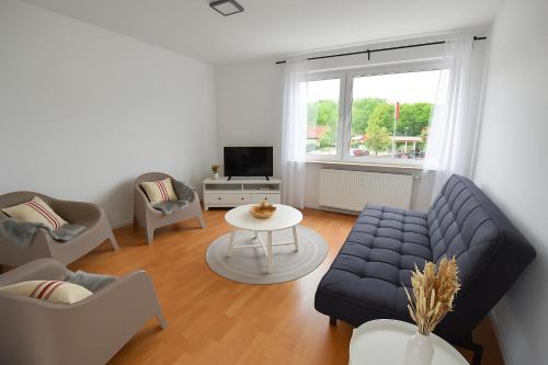 a living room with a blue couch and a table at Penthouse Köln Frechen 2 in Frechen