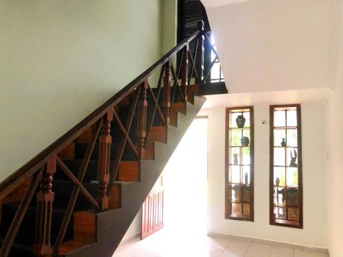 a staircase in a house with a stair case at Hotel Happy Vibes in Galle