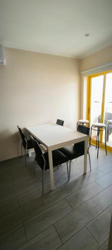 a dining room with a table and chairs in a room at Rocha Apartment Plus in Portimão
