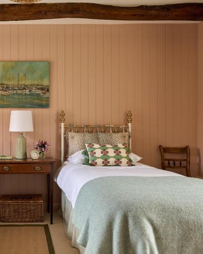 a bedroom with a bed and a table with a lamp at Haybarn Cottage in Alton
