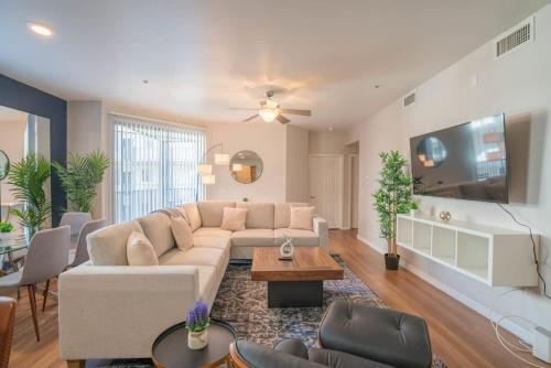 a living room with a couch and a tv at Luxurious 3BD - Gym, W-D, Parking - Sleeps 8 in Tempe