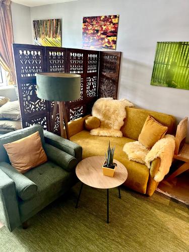 a living room with a couch and a table at Stylish free parking Studio central with balcony in Ålesund