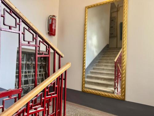 a mirror on the wall next to a staircase at NEW - Old Town Pearl Apartments in Sarajevo