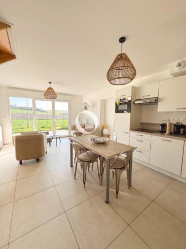 a kitchen and dining room with a table and chairs at COC - Idem in Wissant