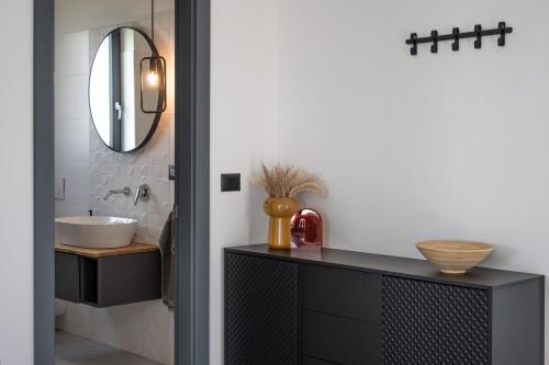 a bathroom with a sink and a mirror at Villa TonKa with jacuzzi sauna and private pool in Labin