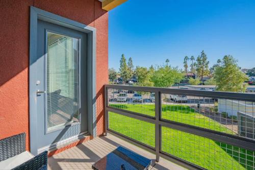 a balcony with a door and a view of a field at Posh 2BD - Gym, Pool, Parking, W-D - Sleeps 8 in Tempe