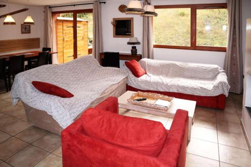 a living room with two beds and a chair at Chalet La Combe D Or - Superbe chalet 10 personnes MAE-3584 in Le Mélézet