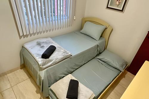 ein kleines Zimmer mit einem Bett und einem Fenster in der Unterkunft P706 - Ar cond Garagem Solda manha in Vitória
