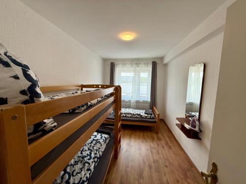 two bunk beds in a small room with a window at Wu Lofts in Wuppertal