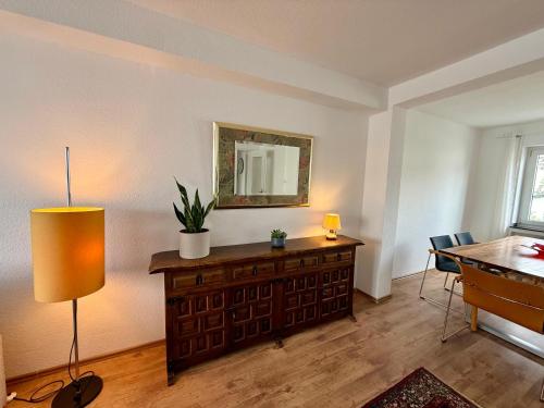 a room with a desk and a table and a mirror at Wu Lofts in Wuppertal