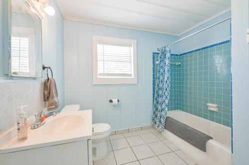a bathroom with a sink and a toilet and a shower at Beach lovers dream come true walking distance to the sandy shores in Galveston