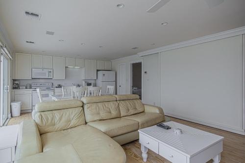 a living room with a couch and a kitchen at Original Margaritaville Beachfront Paradise Found. in Galveston