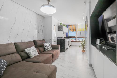 a living room with a couch and a tv at Endless Seaview Patalavaca in Patalavaca