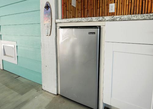 a refrigerator in a garage next to a wall at Kemah Baydreaming Near Kemah Boardwalk in Kemah