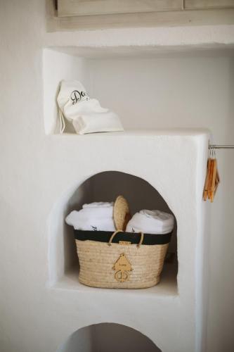 a basket in a shelf in a wall at Dar Naël in Houmt Souk