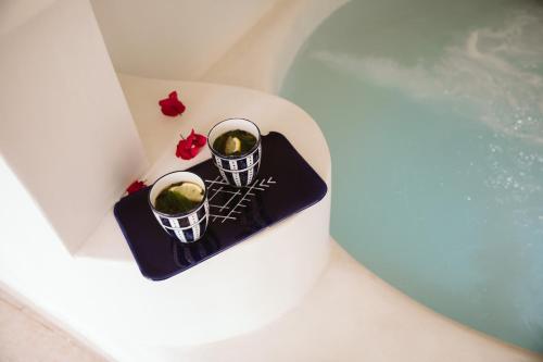 two candles sitting on top of a bath tub at Dar Naël in Houmt Souk