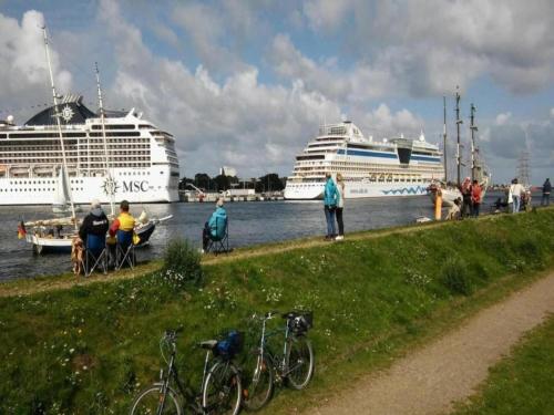 two cruise ships are docked at a dock with bikes at Wohnung nahe Ostsee Graal Müritz Strand in Rövershagen