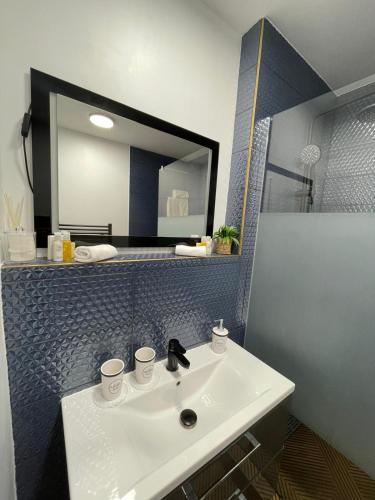 a bathroom with a white sink and a mirror at New Kelly Apartment in Levoča
