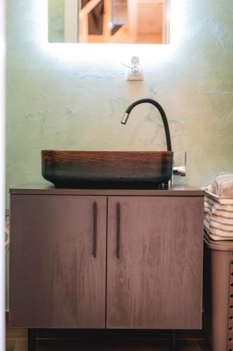 a sink on top of a cabinet in a bathroom at Olive Hills holiday homes 3 in Dobra Voda