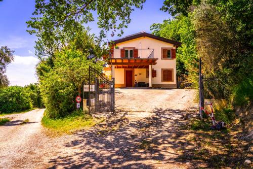 a house with a gate on a dirt road at Bed & Breakfast Duchessa - 2 Private Rooms with Ensuite Bathrooms in Lapedona
