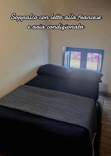 a bed in a room with a black mattress at Villa Vista Mare a Filicudi in Filicudi