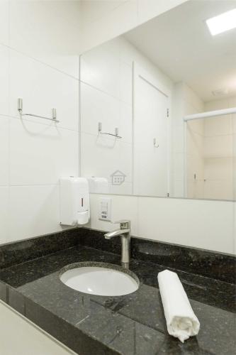 a bathroom with a sink and a mirror at Edifício Link by Rezervo in Santo Antônio
