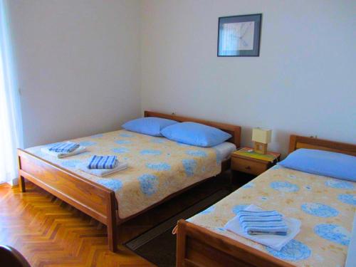 a bedroom with two beds with blue pillows at Apartman Tomas in Povile