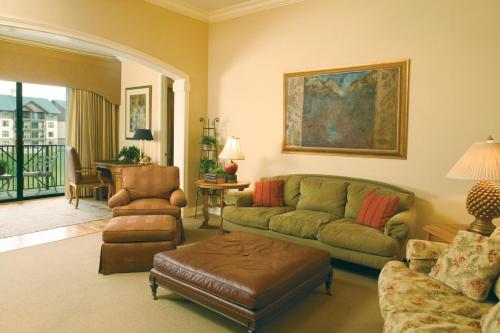 a living room with a couch and a chair at Club Wyndham Smoky Mountains in Pigeon Forge