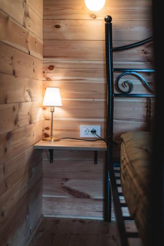 a room with a bunk bed with a desk and a lamp at Olive Hills holiday homes 3 in Dobra Voda