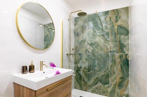 a bathroom with a sink and a mirror at Apartments Doro in Vela Luka