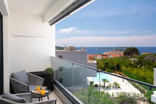 a balcony with a view of the ocean at Prestige Apartment Primošten in Primošten
