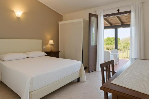 Ένα ή περισσότερα κρεβάτια σε δωμάτιο στο Agriturismo Nuraghe Tuttusoni
